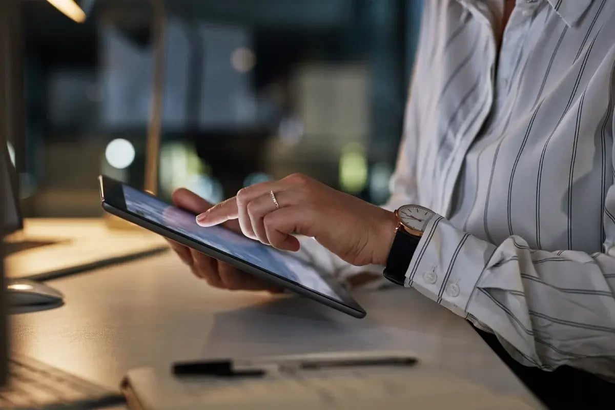 Closeup shot of an unrecognisable businesswoman using a digital tablet in an office at night