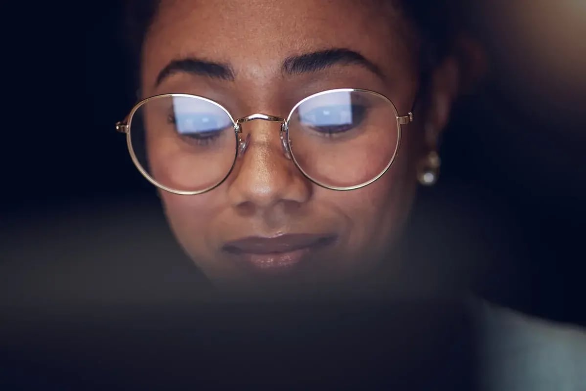 Laptop, student face and night woman reading, studying and learning online information, education or check college database. Analysis, research and closeup person education, working and typing essay