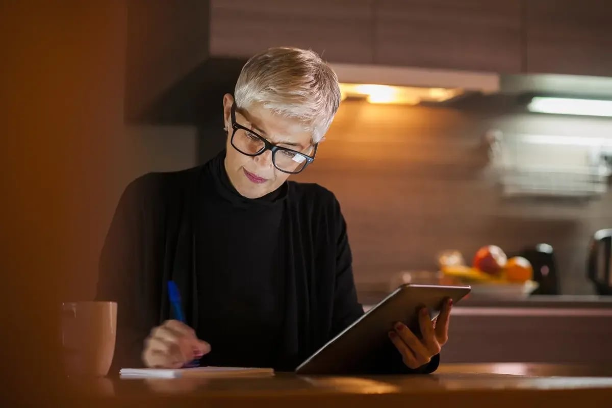 Beautiful mature woman working on computer late at night